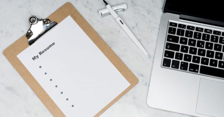 Woman working on laptop at home earning extra income